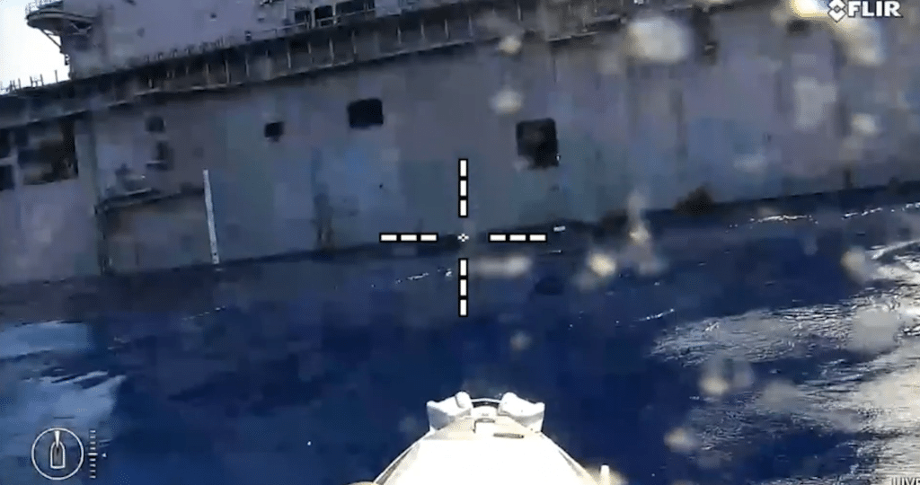 U.S. Navy unmanned surface vessels take part in a RIMPAC 2026 sinking exercise targeting the former USS Peleliu. - U.S. Navy video capture