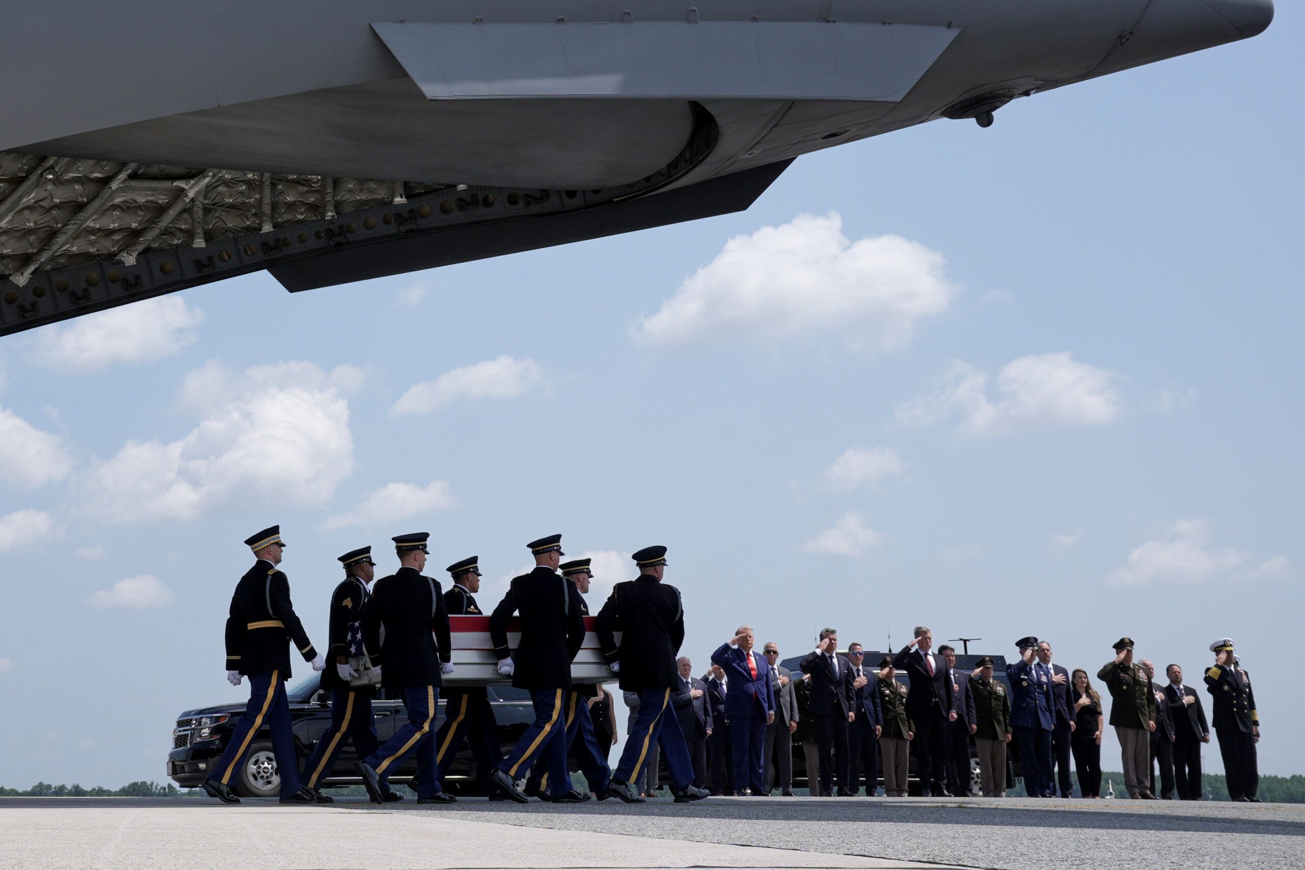 President Trump and Defense Secretary Pete Hegseth salute as a U.S. Army carry team moves a transfer case containing the remains of Sgt. Angel S. Rampersad at Dover Air Force Base on July 22, 2026. - AP Photo/Matt Rourke