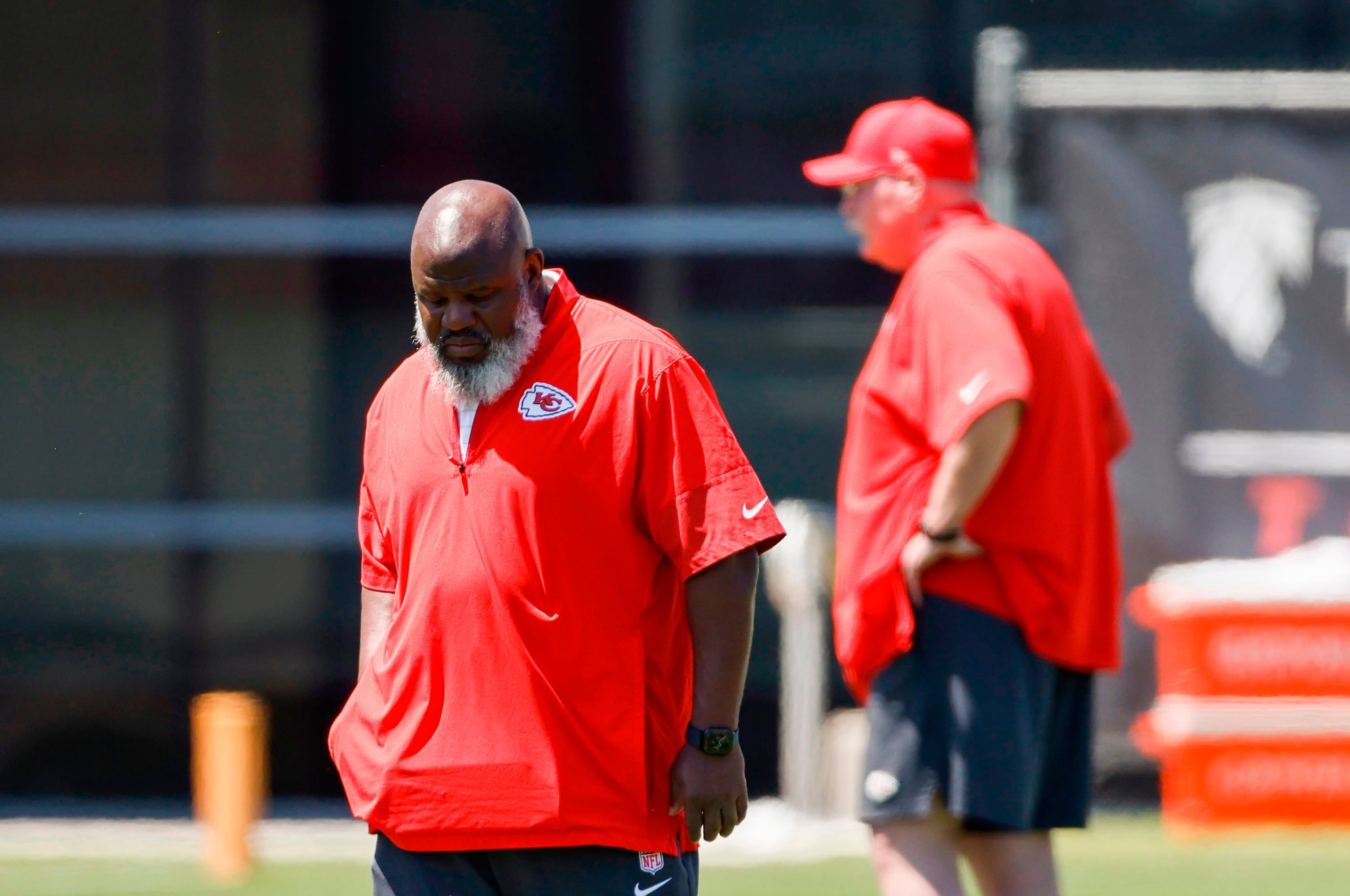 Kansas City Chiefs offensive coordinator Eric Bieniemy walks upfield from head coach Andy Reid during rookie minicamp in Kansas City, Missouri, on May 2, 2026. - AP Photo/Colin E. Braley