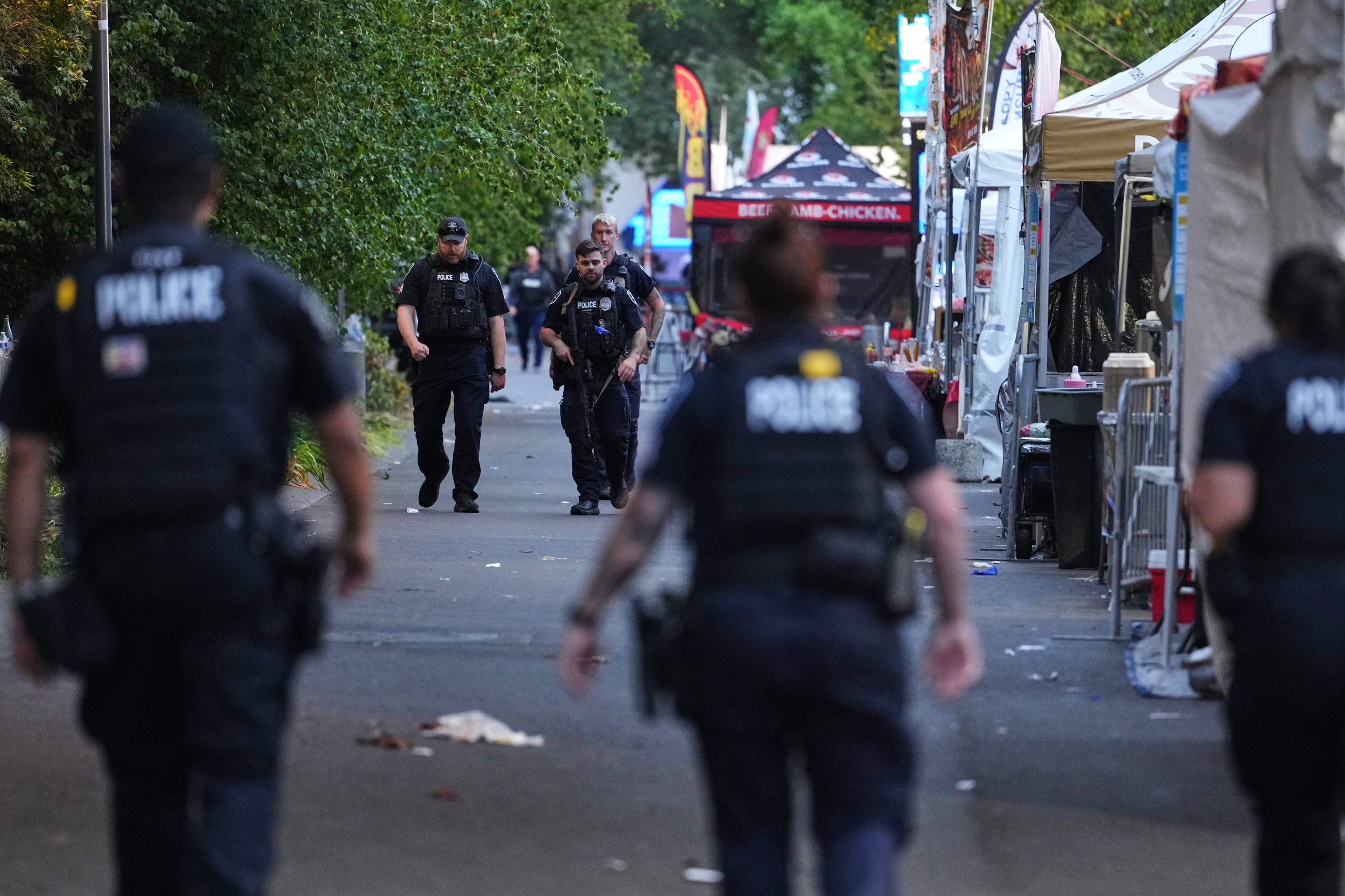 Seattle Police walk the scene after responding to a shooting at Seattle Center during the Bite of Seattle food festival on Sunday. - theglobeandmail.com