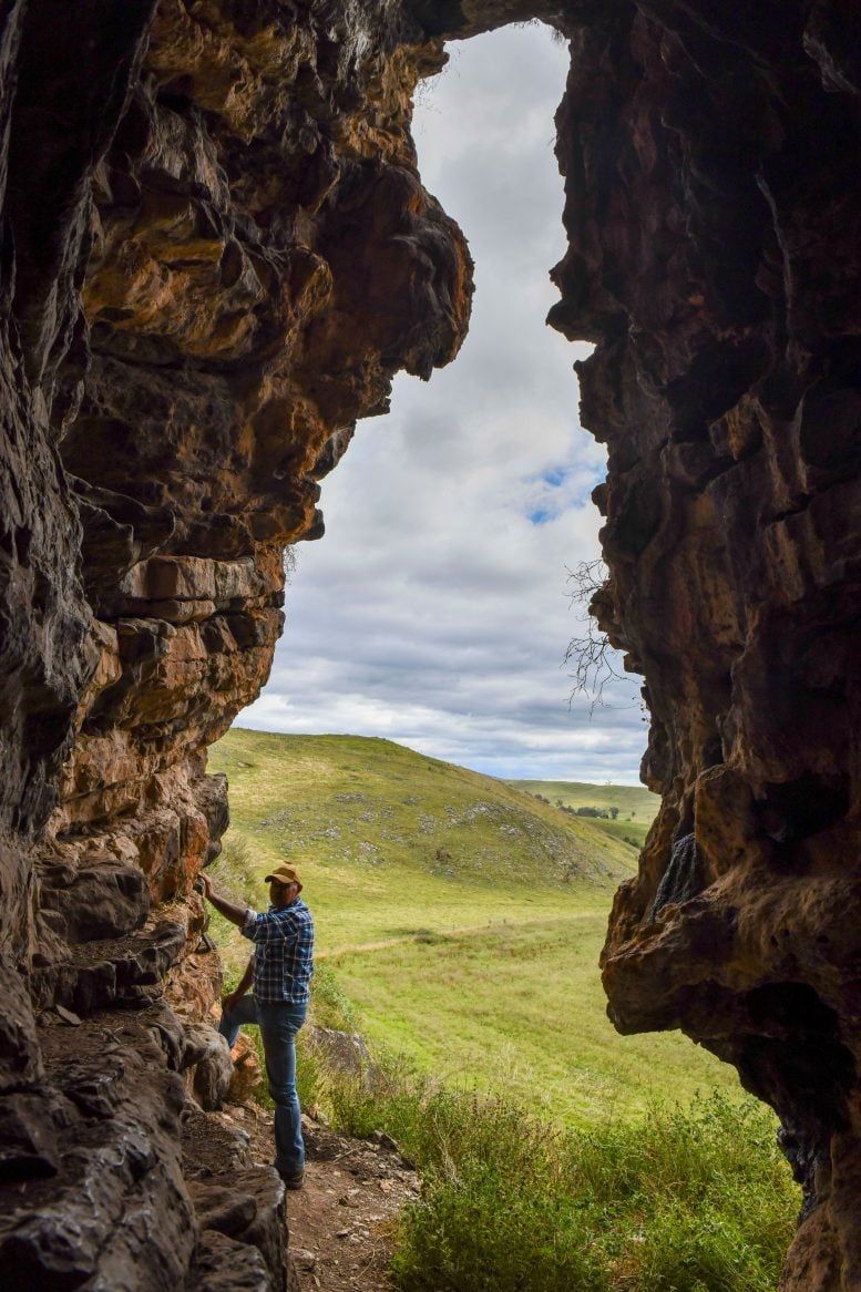 GunaiKurnai Elder Uncle Russell Mullett at the entrance of Cloggs Cave. - Jess Shapiro, courtesy of GunaiKurnai Land and Waters Corporation