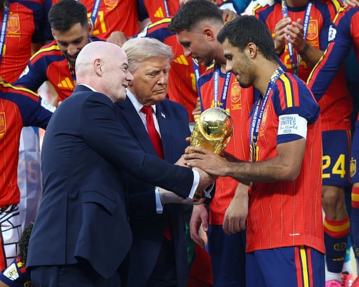 Gianni Infantino and President Trump hand the World Cup trophy to Rodri after the final. - Hannah McKay/Reuters