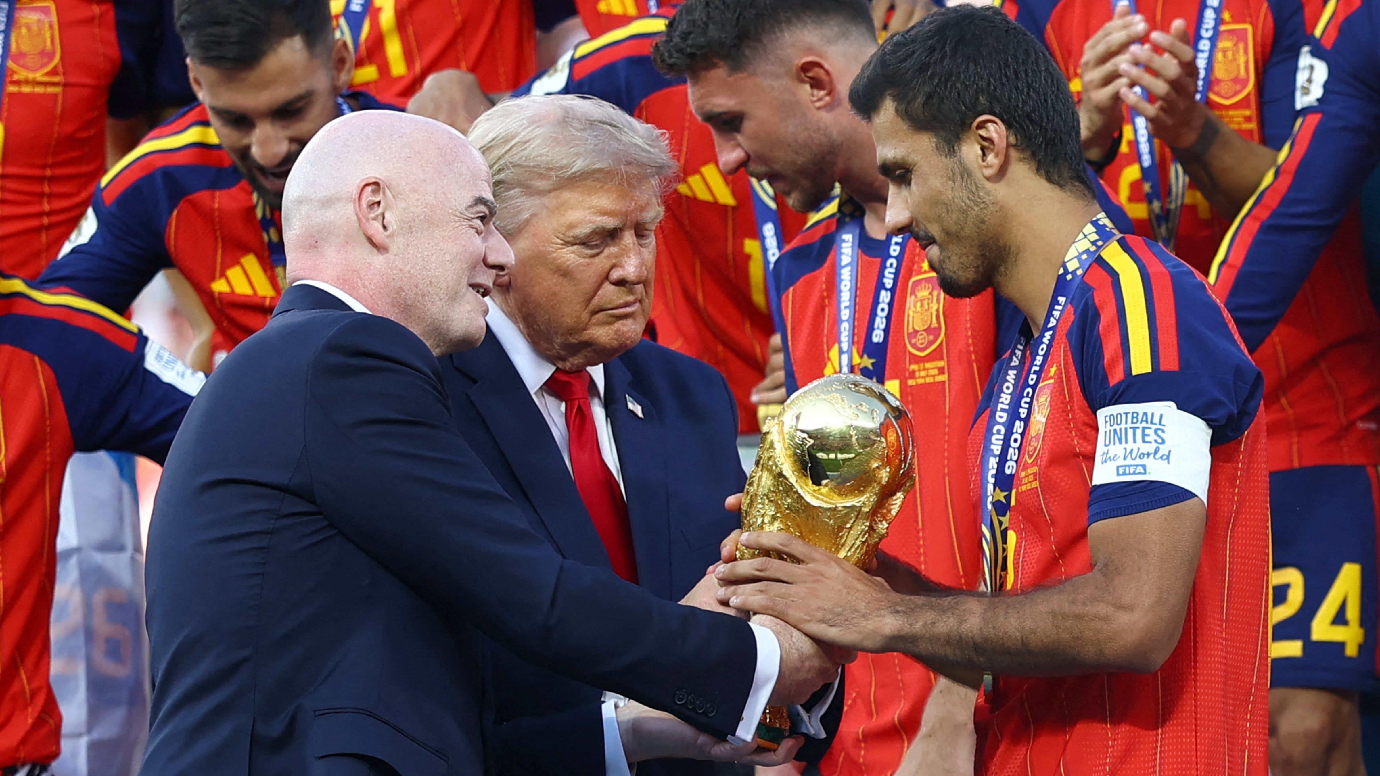 US President Donald Trump and Fifa president Gianni Infantino hand the World Cup trophy to Spain's Rodri. - Reuters