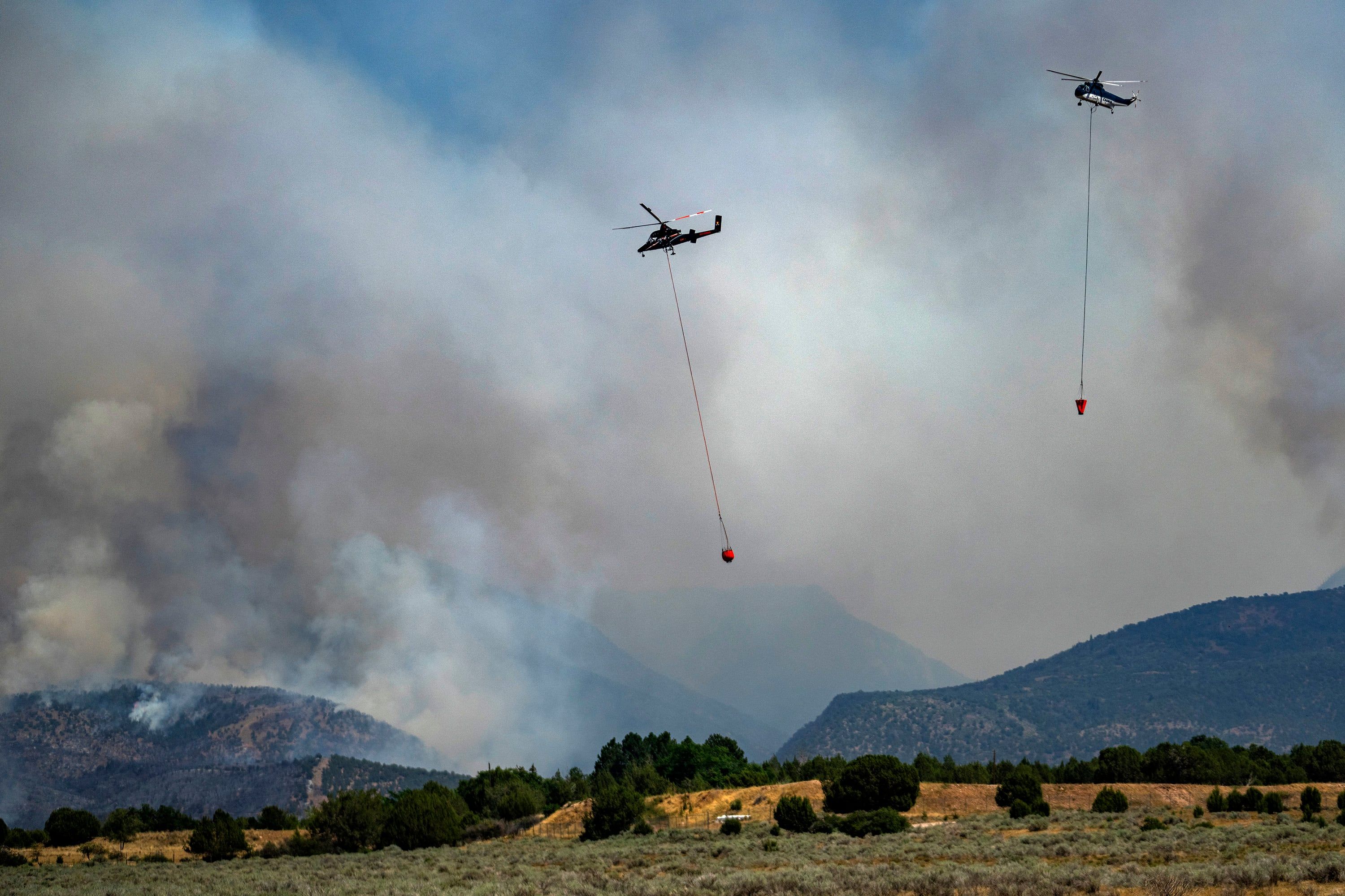 Helicopters work on the Widemouth 2 Fire near Fillmore on Aug. 3, 2026. - Rick Egan/The Salt Lake Tribune