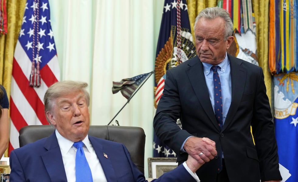 President Donald Trump shakes hands with Health and Human Services Secretary Robert F. Kennedy Jr. during an Oval Office meeting to sign an executive order about vaccines. - Associated Press/Jacquelyn Martin