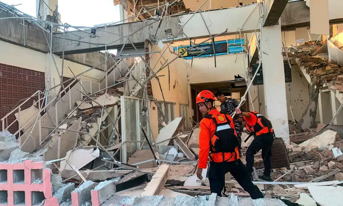 Rescuers work amid the rubble of a damaged building after the earthquake in Maumere, East Nusa Tenggara. - BASARNAS/AFP