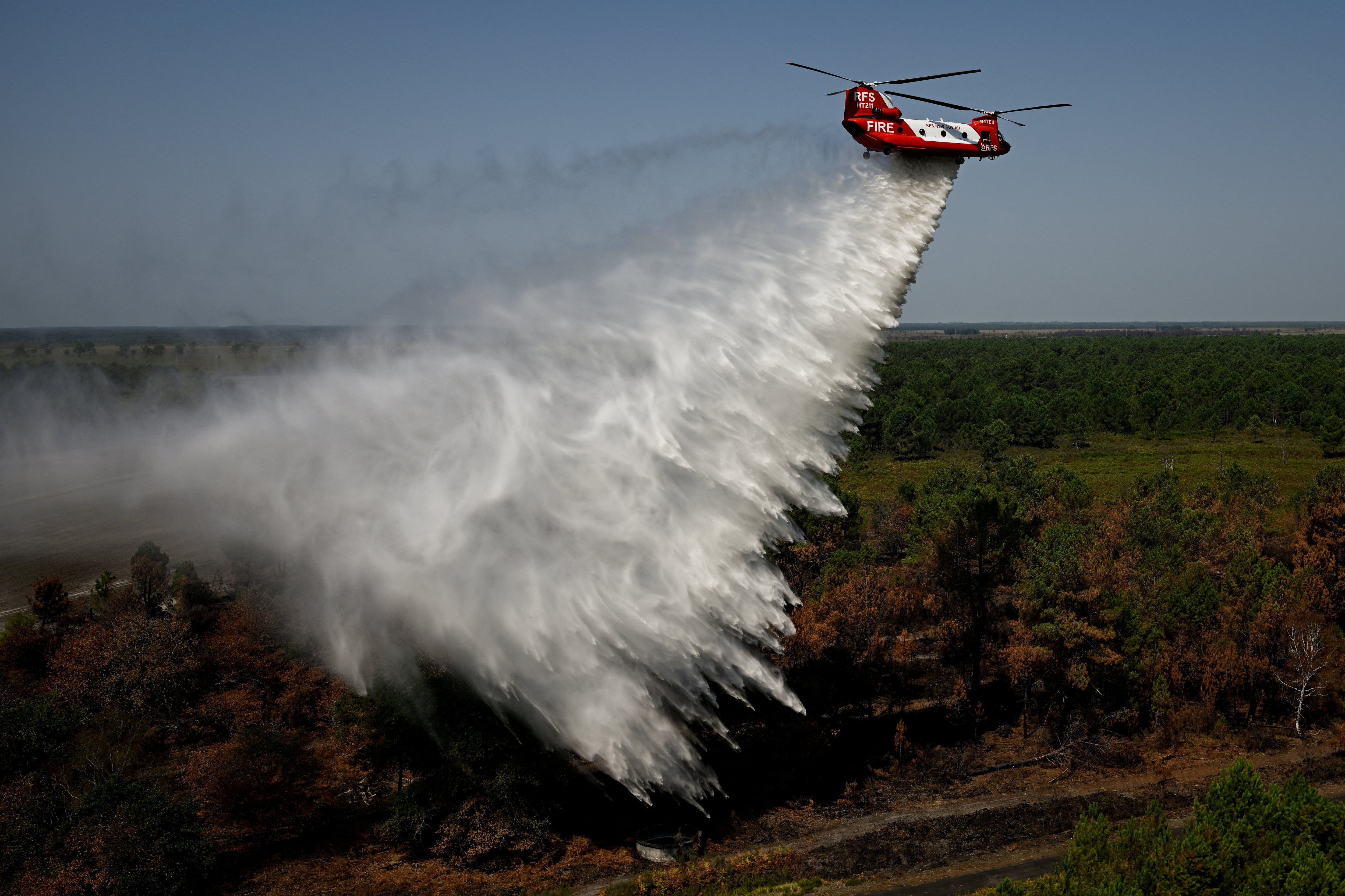 A CH-47D Chinook water-bombing helicopter over France during drought-driven wildfires. - Reuters