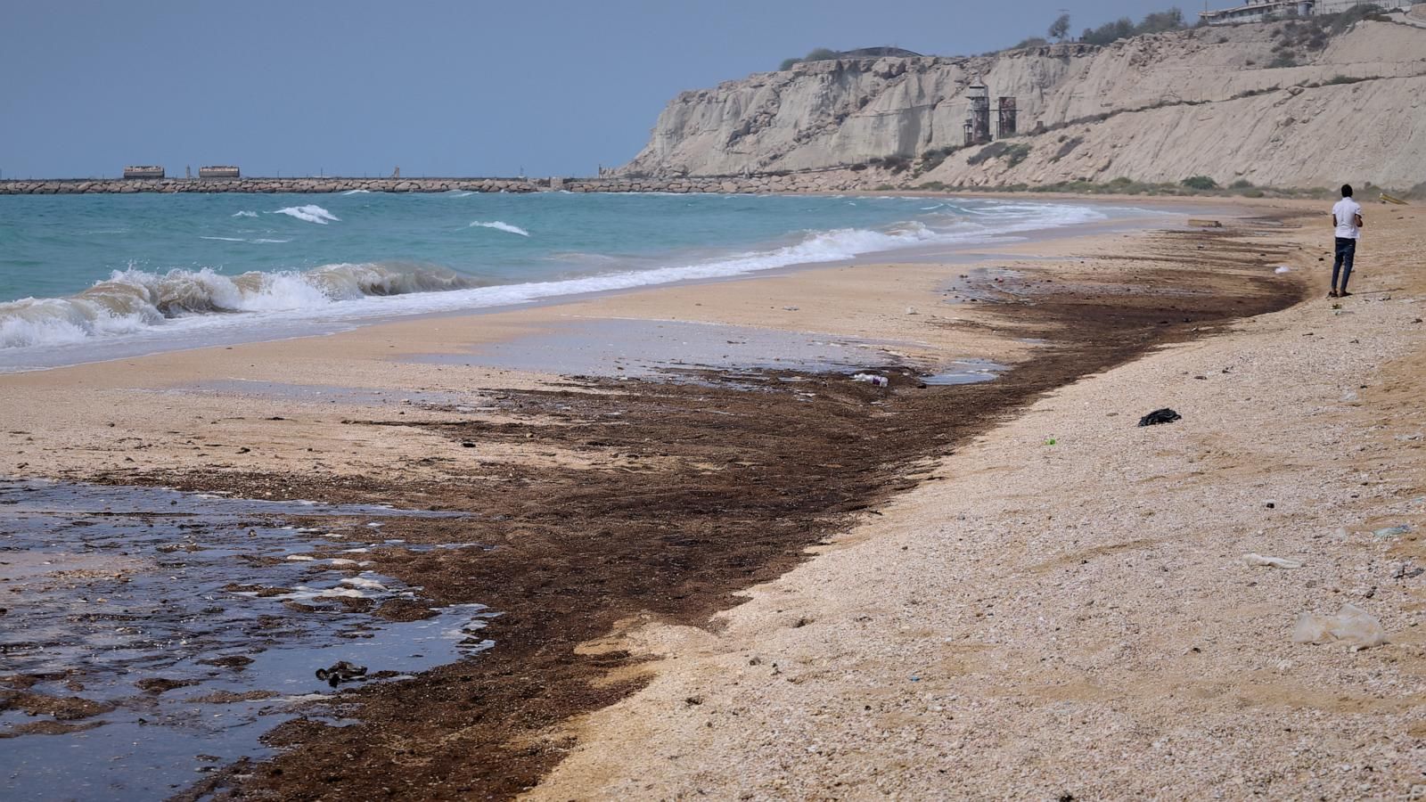 Dark oil residue on the shoreline at Shib Deraz Beach on Qeshm Island, Iran, amid wartime attacks around the Strait of Hormuz. - Amirhosein Khorgooei/ISNA via AP