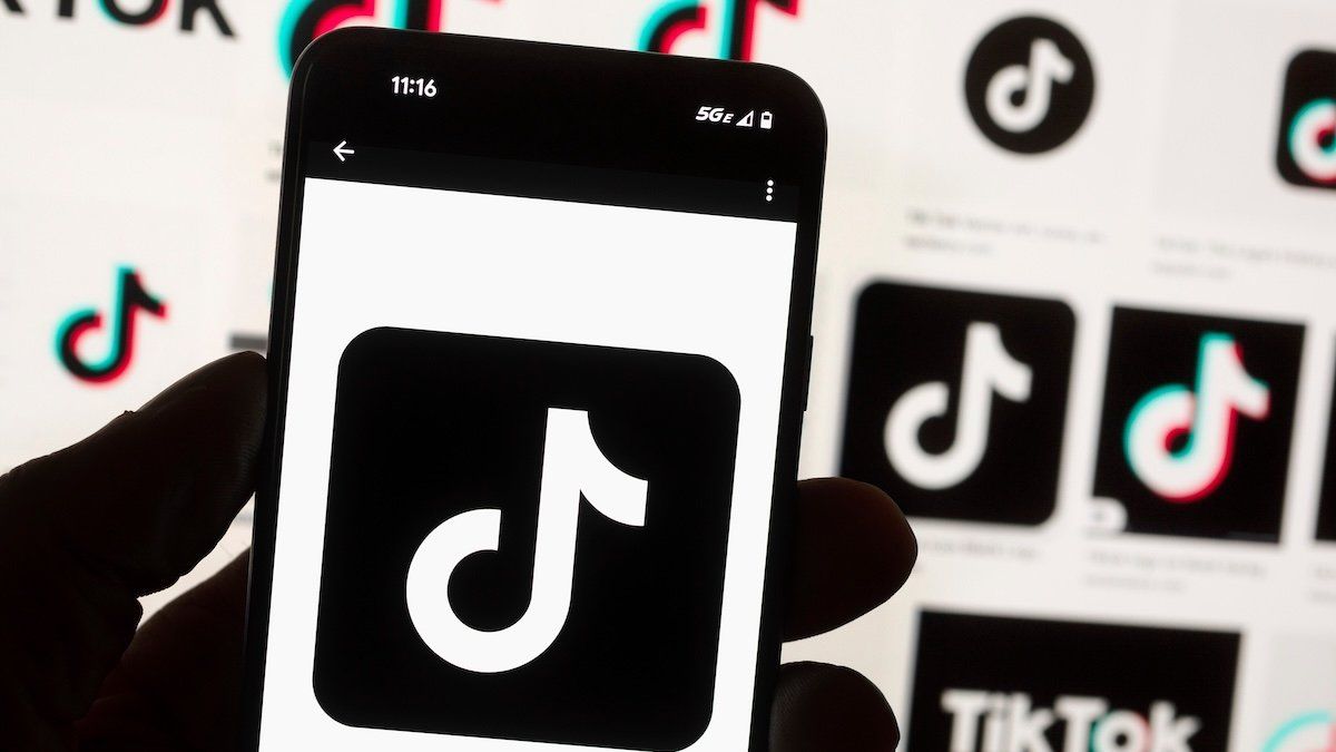 The TikTok logo is displayed on a mobile phone in front of a computer screen, Oct. 14, 2022, in Boston. - Michael Dwyer/AP