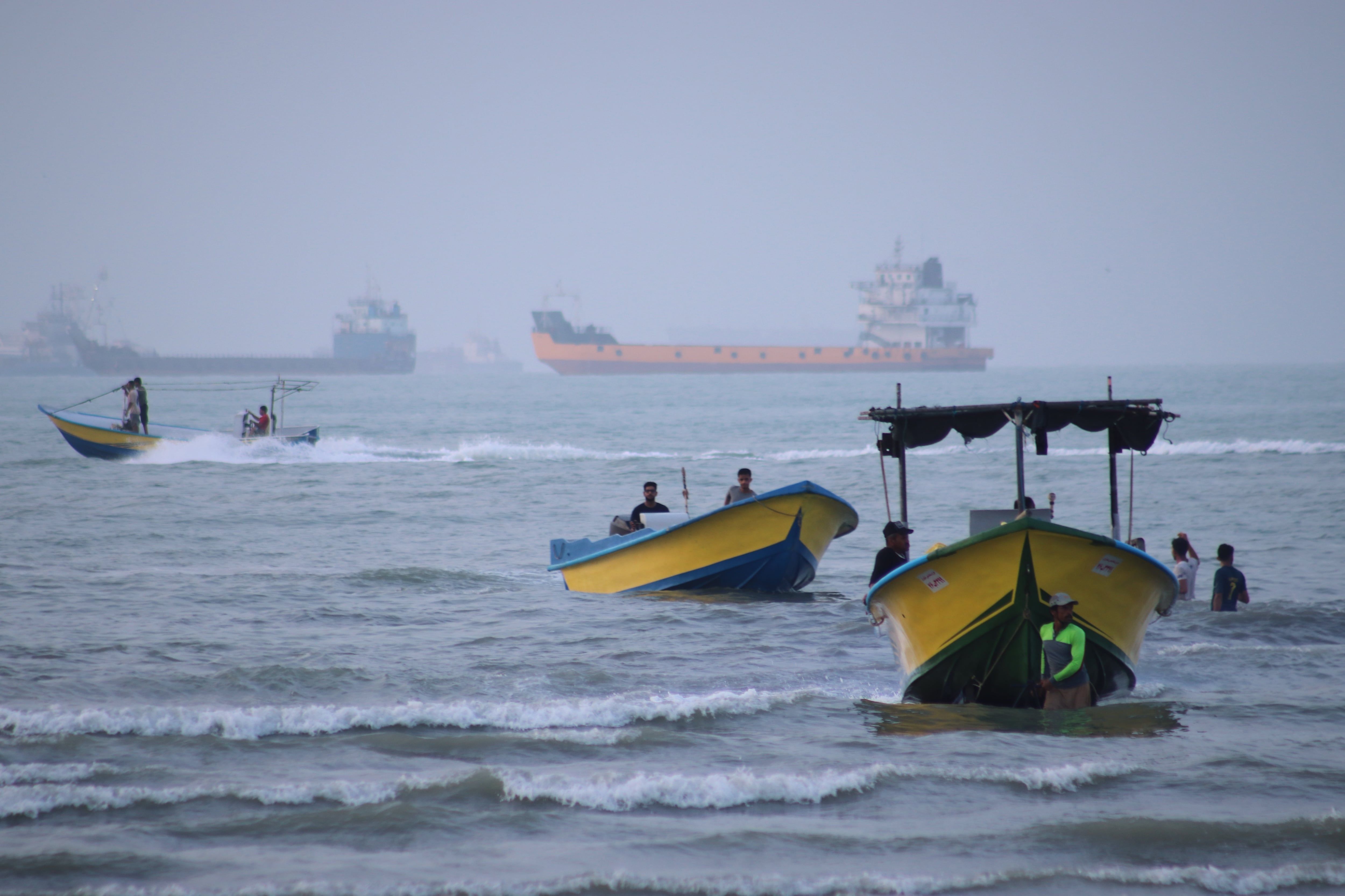 Small boats line the shore as cargo ships and other commercial vessels appear anchored in the Strait of Hormuz off Bandar Abbas, Iran, Monday, July 27, 2026. - Razieh Poudat/ISNA via AP