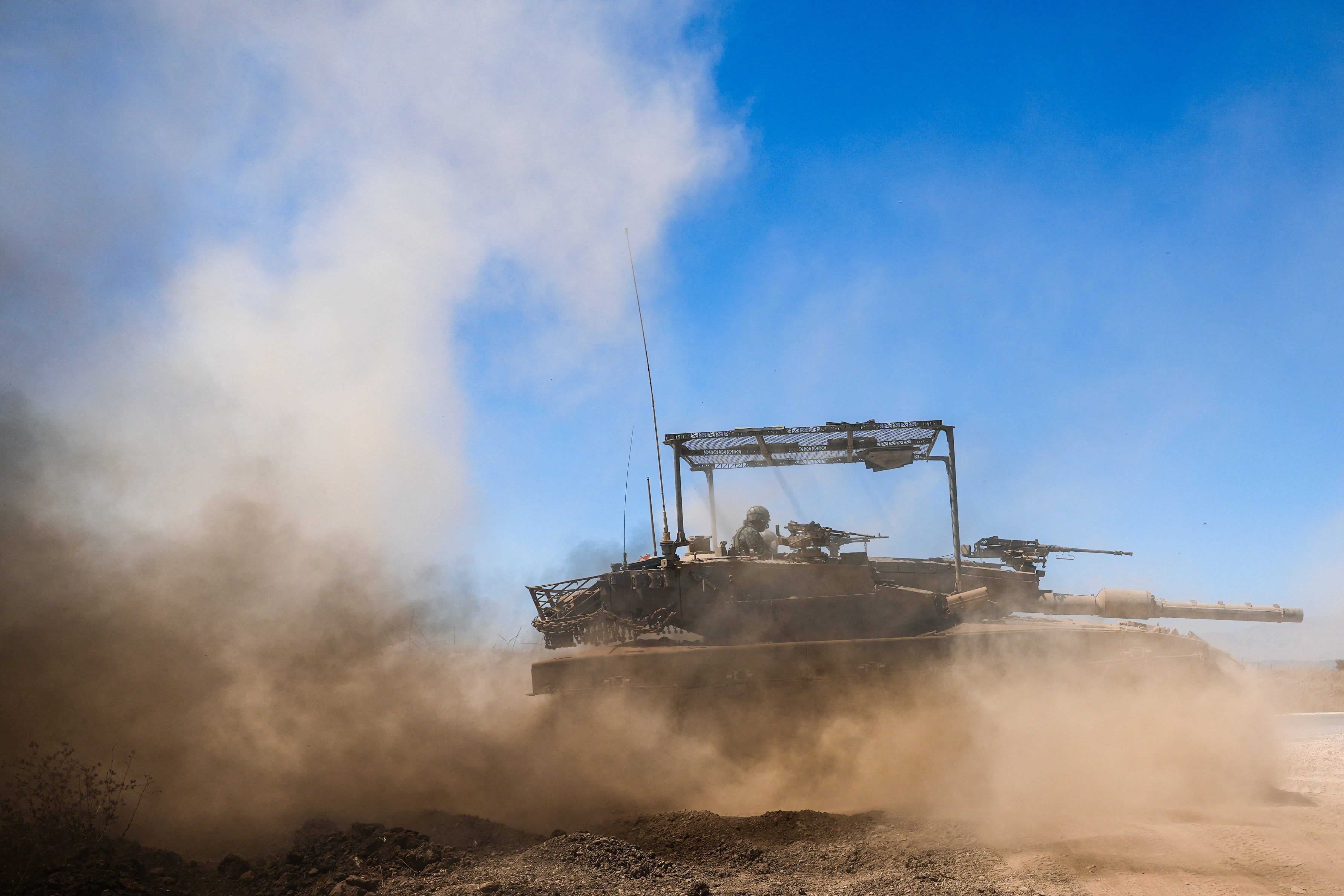 An Israeli tank drives along the ceasefire line between the Israeli-occupied Golan Heights and Syria. - Reuters