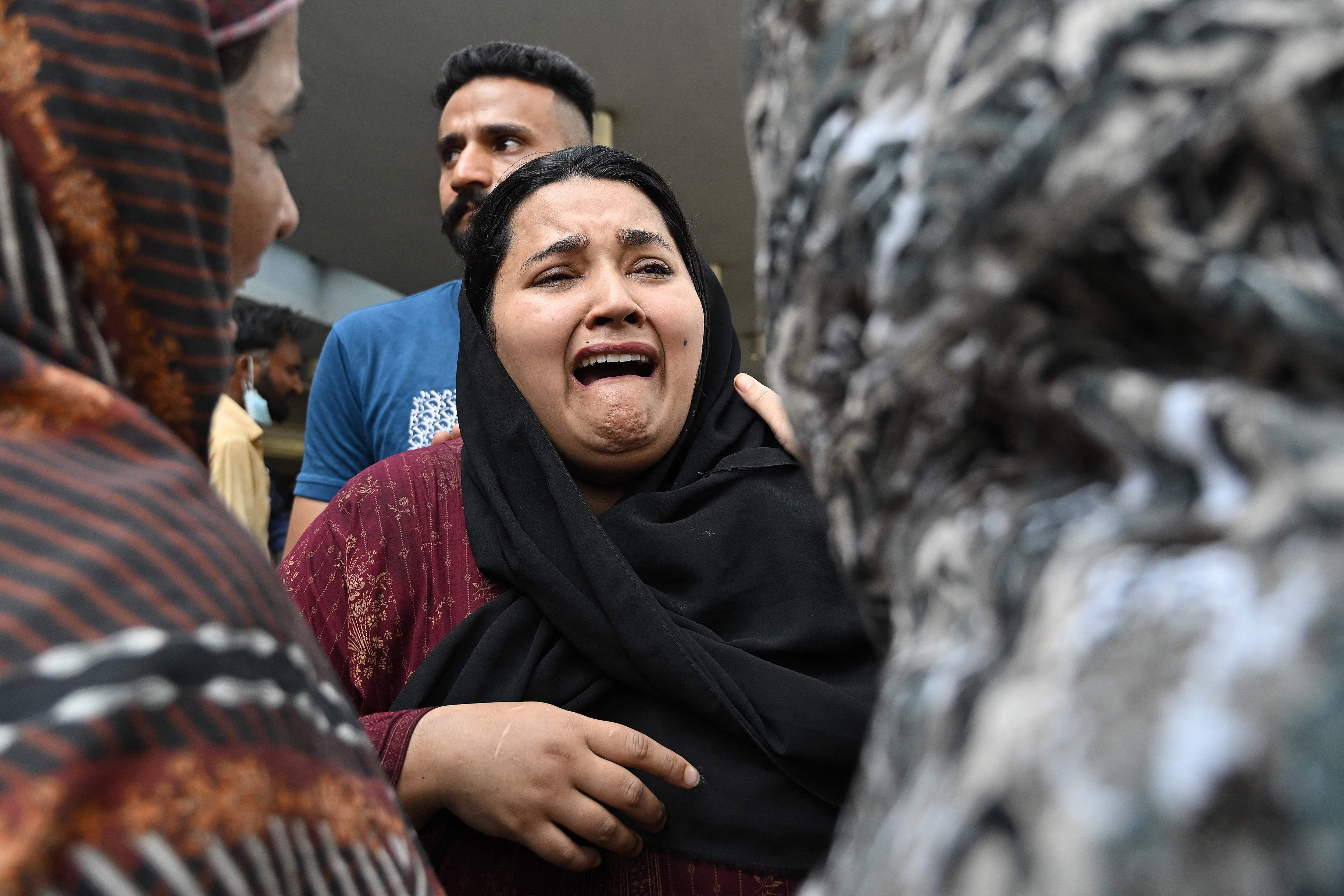 A mother reacts after the death of her child outside the Mother and Child Health ward at PIMS Hospital in Islamabad on August 26, 2026. - Aamir Qureshi/AFP