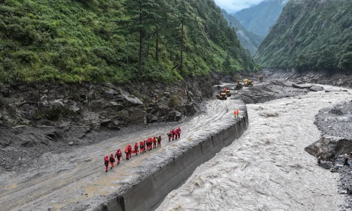 A drone view of firefighters conducting search and rescue operations at a damaged road leading to Gyirong Port after a mudslide, in Gyirong county, Shigatse, Tibet Autonomous Region, China on August 28, 2026. - Reuters