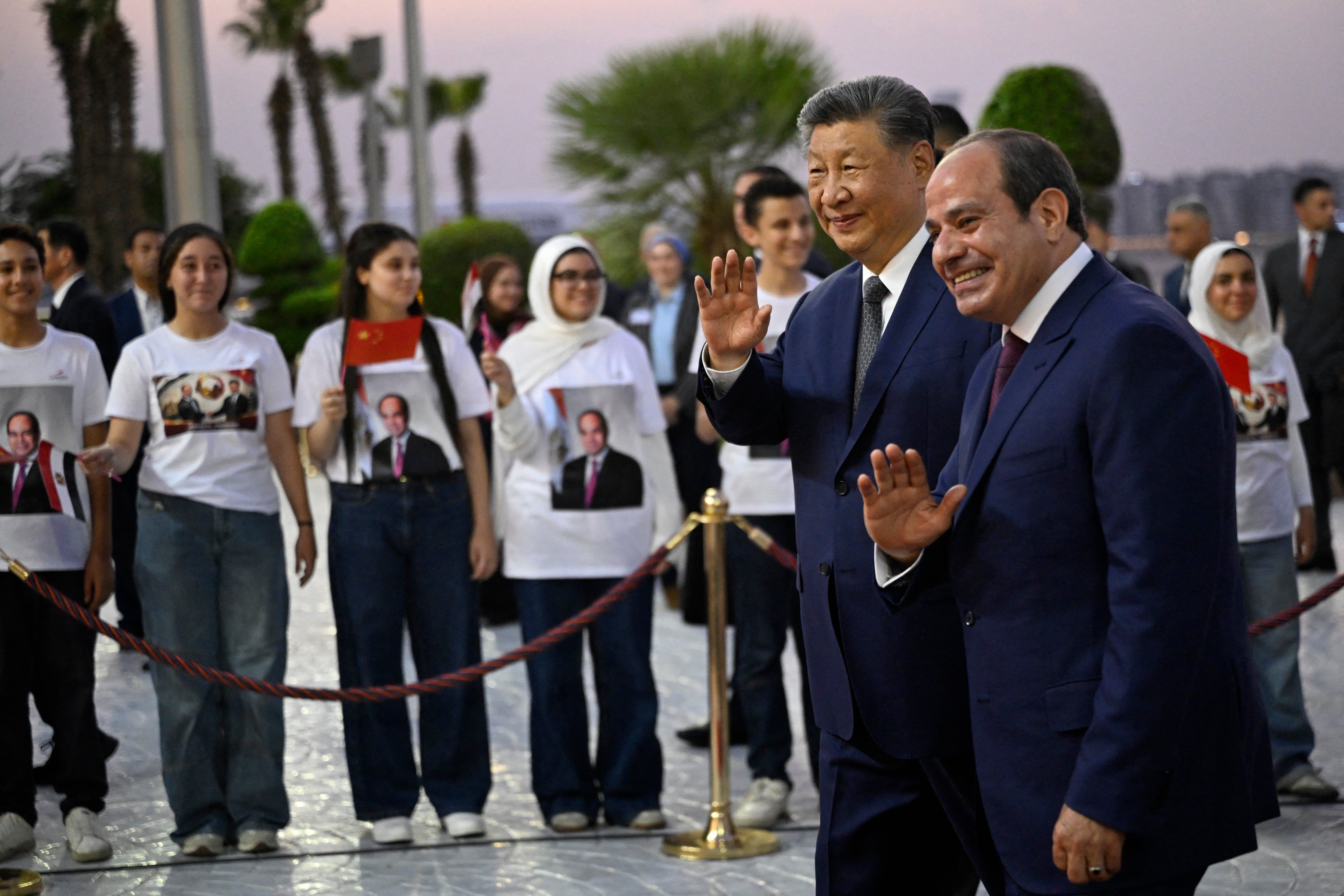 China's President Xi Jinping and Egyptian President Abdel Fattah al-Sisi wave upon Xi’s arrival at Cairo International Airport on September 1, 2026. - Khaled Desouki / Pool / AFP via Getty Images