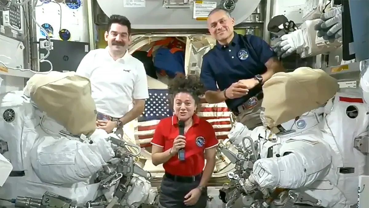 Two men and a woman speak from the International Space Station. - NASA