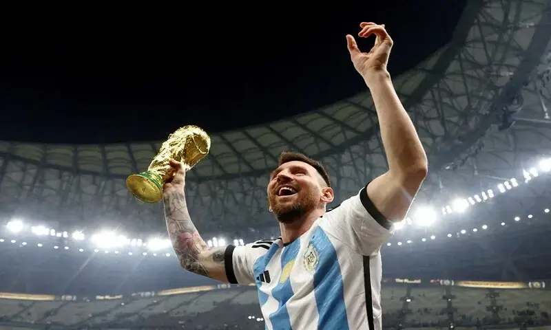Lionel Messi celebrates with Argentina’s 2022 World Cup trophy in Qatar. - Reuters